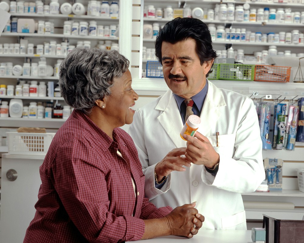 Pharmacien et cliente au comptoir